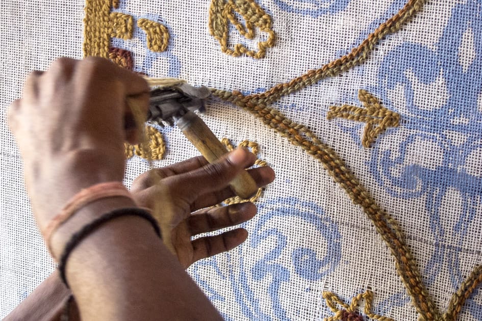Artisan handcrafting a rug with intricate design at Bhadohi Carpets House, India