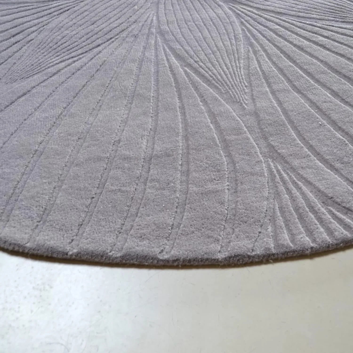 Round wool carpet rug with textured swirl pattern from Bhadohi Carpets House, India