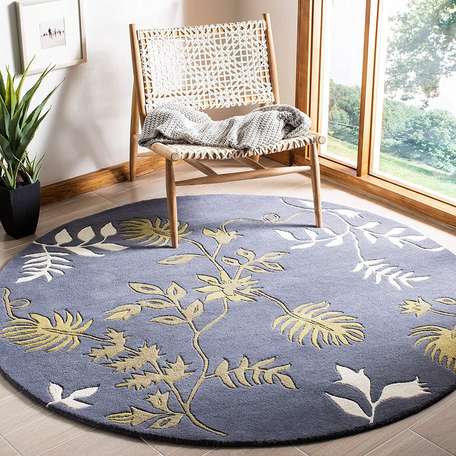 Blue round wool rug with leaf pattern in a modern living room, Bhadohi Carpets House