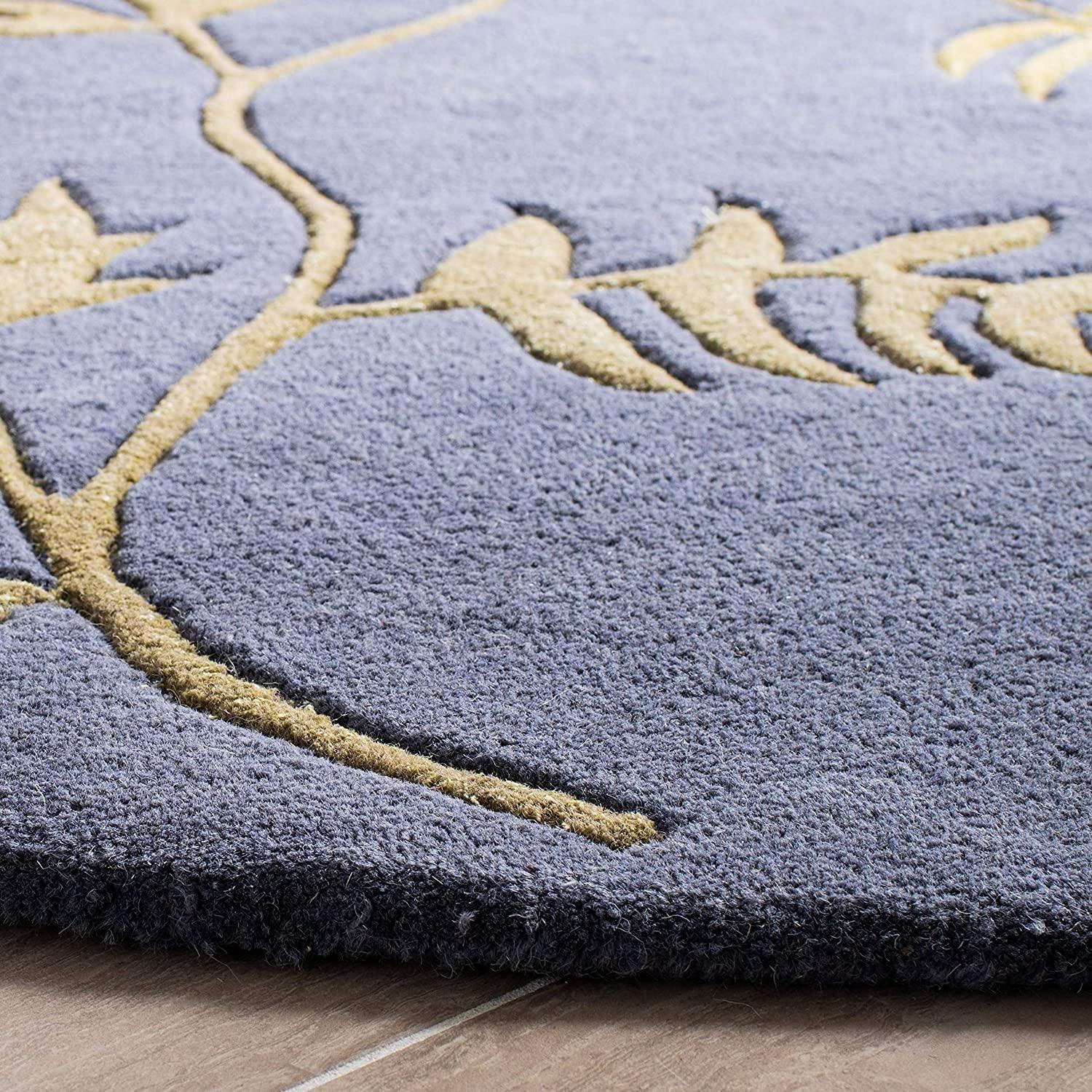 Blue round wool carpet rug with leaf pattern from Bhadohi Carpets House on a tiled floor