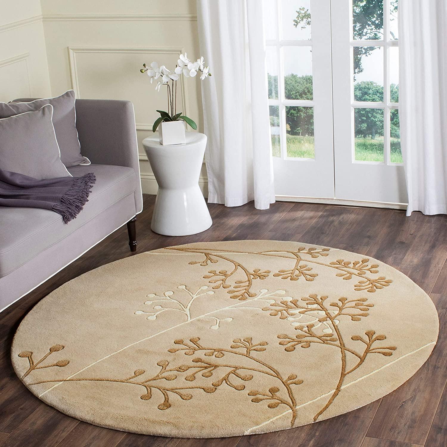 Round wool carpet with camel and berry branch design in a modern living room, Bhadohi Carpets House