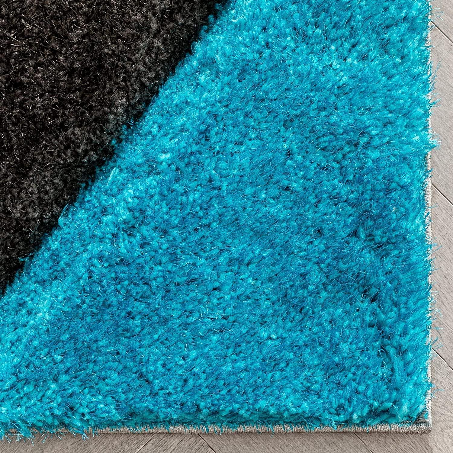 Close-up of a modern blue and black shaggy carpet rug from Bhadohi Carpets House on wood floor