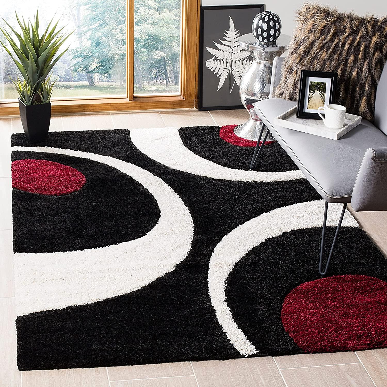 Modern shaggy carpet rug with black, white, and red abstract design in a stylish living room