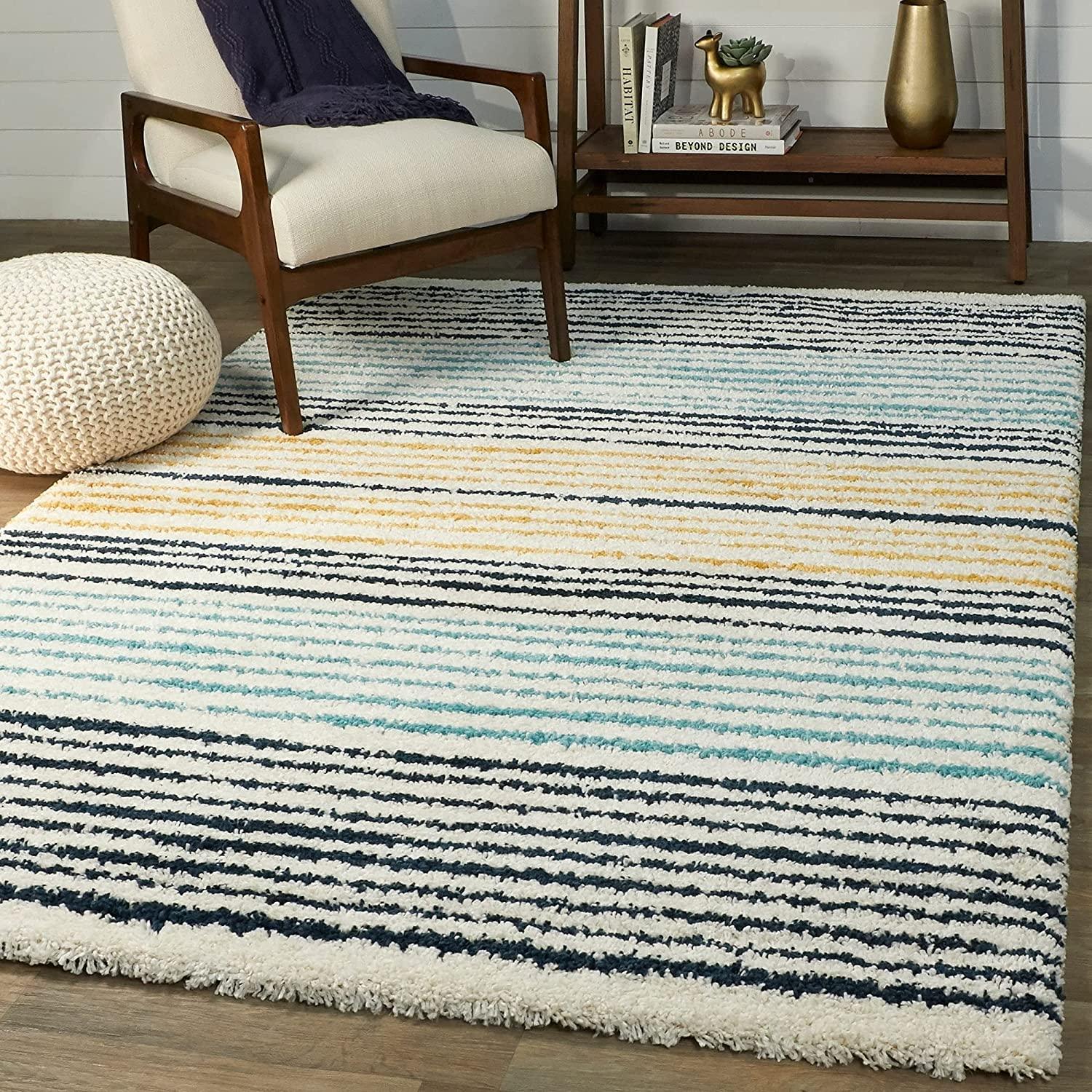 Modern ombre shaggy carpet with blue, yellow, and white stripes in a cozy living room setting