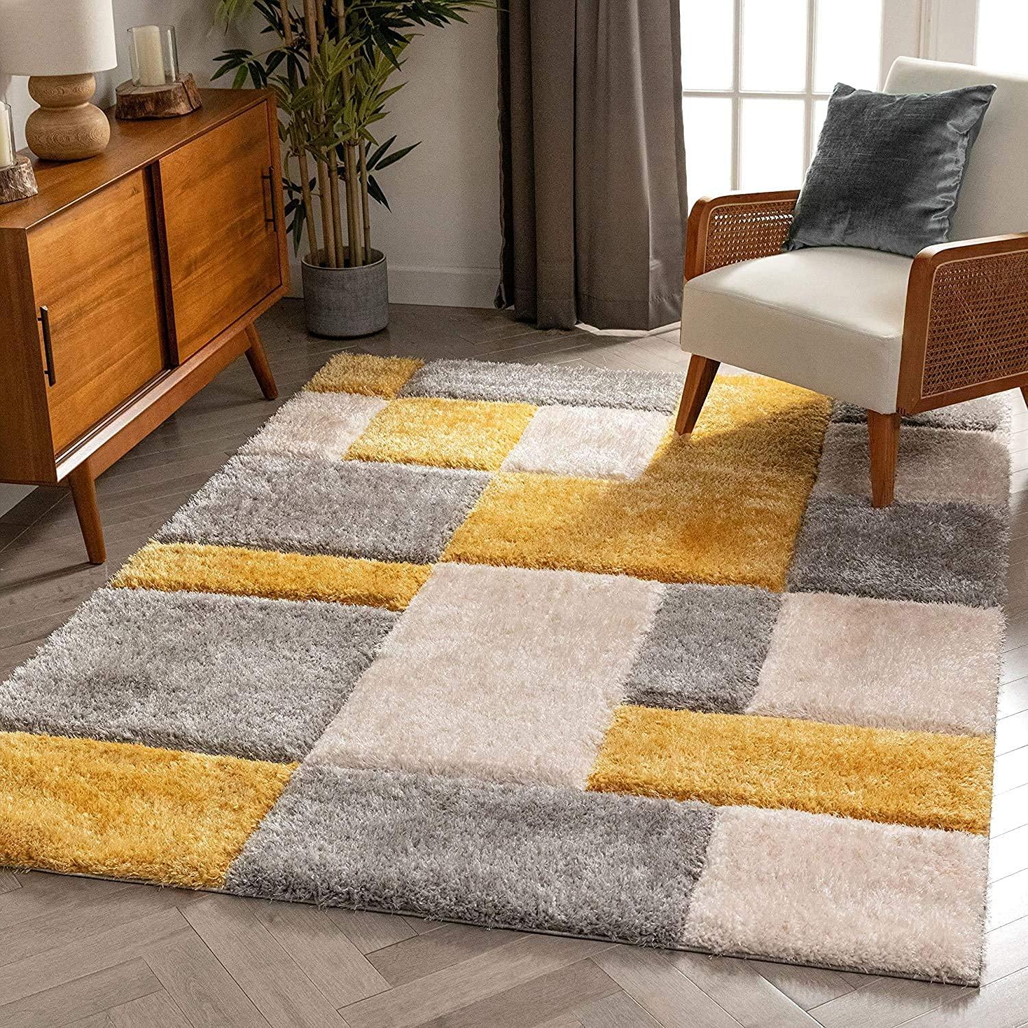 Modern shaggy carpet rug in yellow, grey, and cream hues in a cozy living room setting