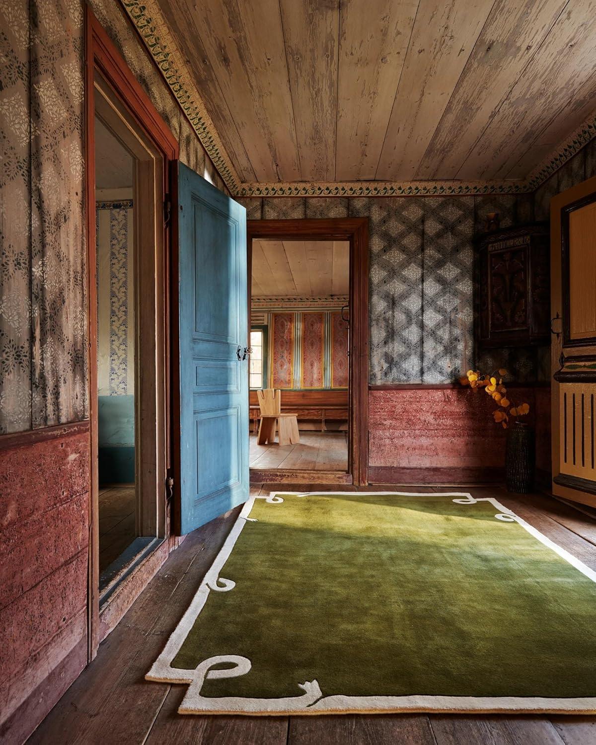 Green irregular carpet rug with white border in a rustic vintage room from Bhadohi Carpets House