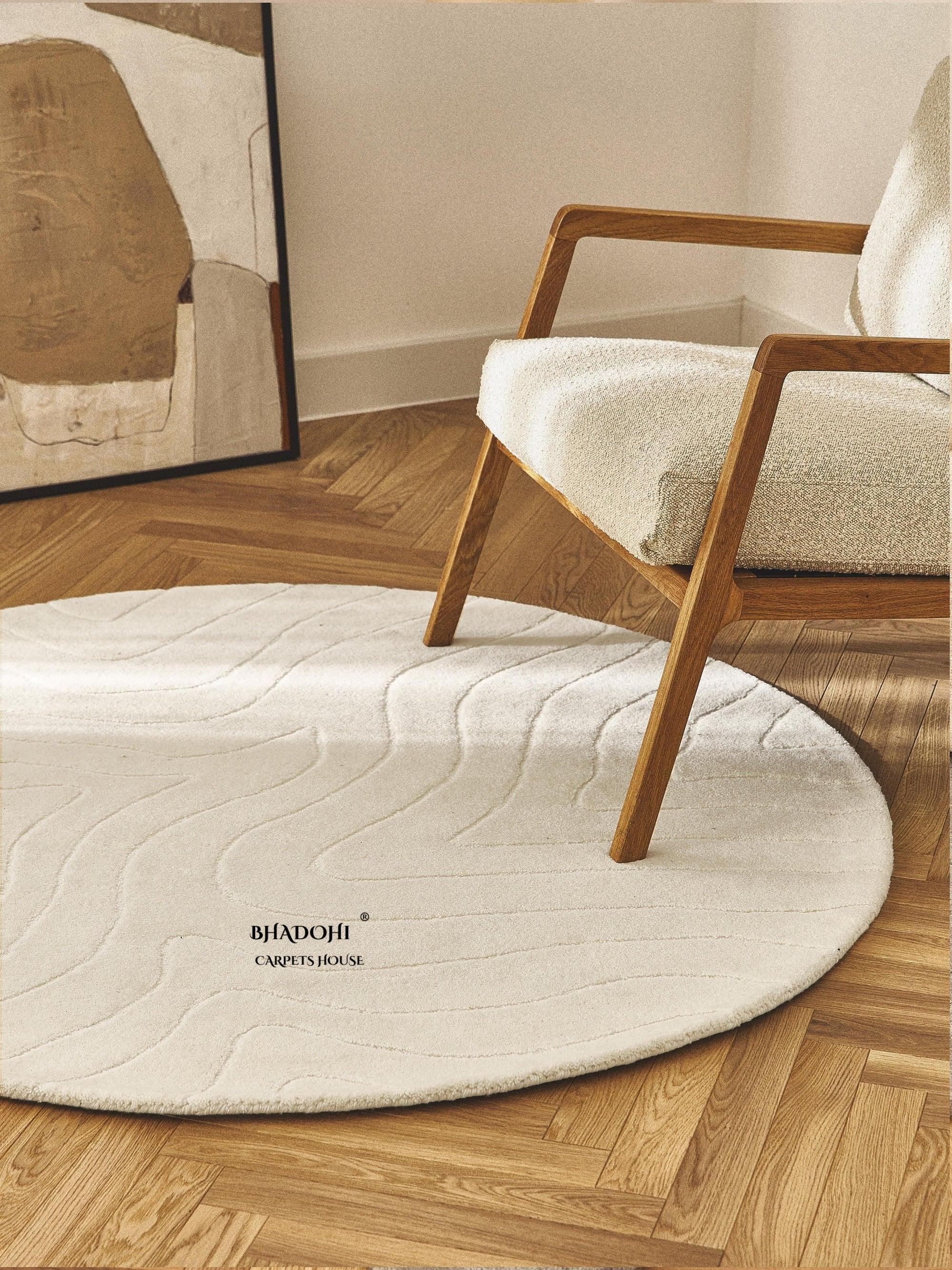 Round wool carpet rug by Bhadohi Carpets House in a modern living room with wooden chair