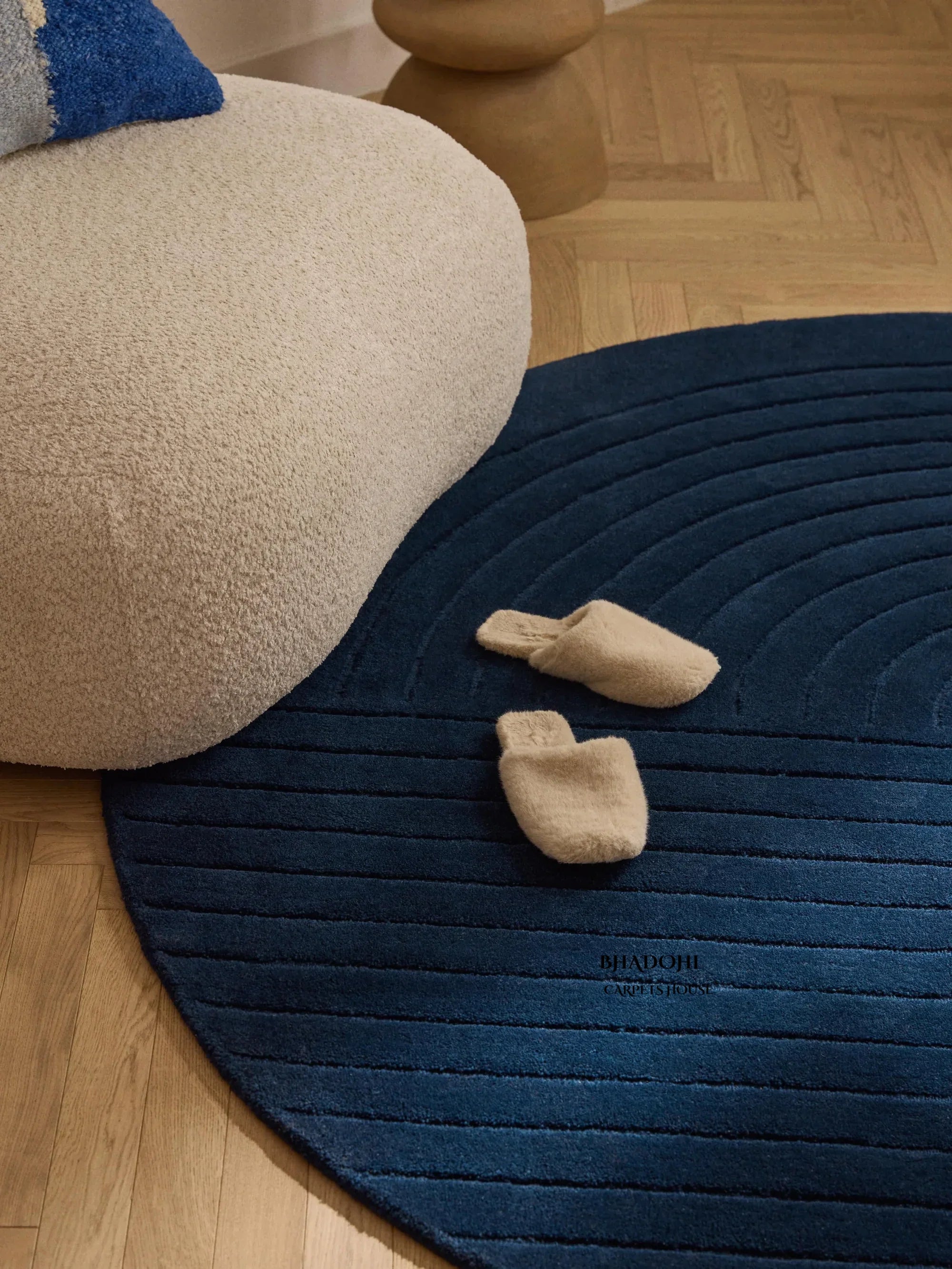 Round blue wool carpet from Bhadohi Carpets House, with slippers and modern decor