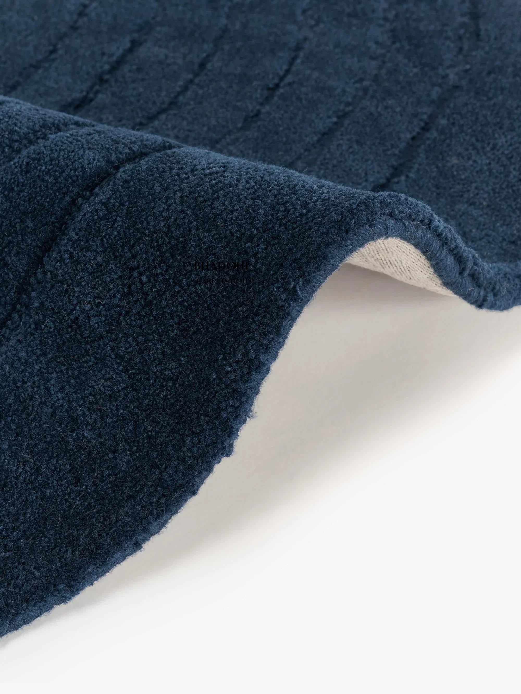 Blue wool round carpet rug close-up, textured pile, Bhadohi Carpets House