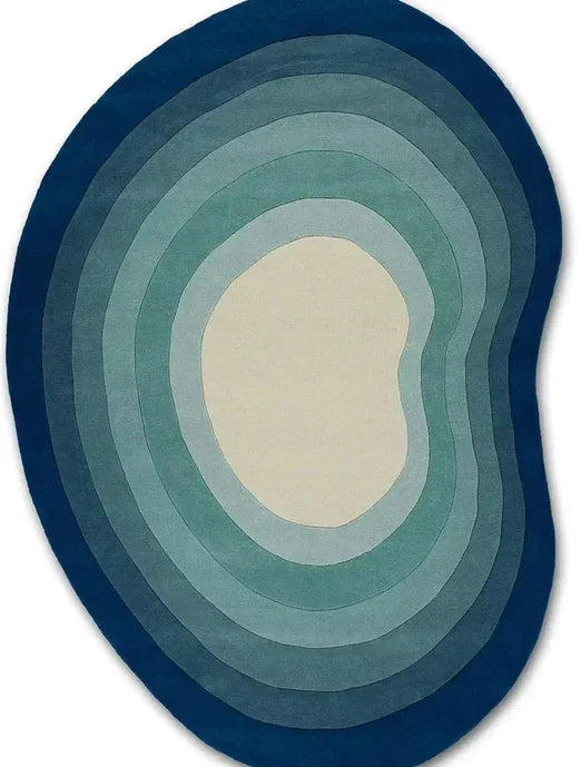 Modern abstract blue and cream irregular-shaped Bhadohi carpet rug on white background