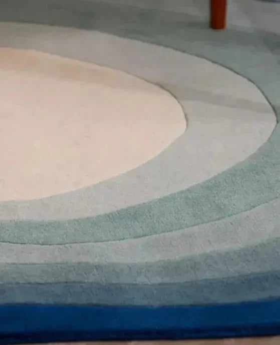 Modern oval carpet rug with gradient blue and beige rings from Bhadohi Carpets House