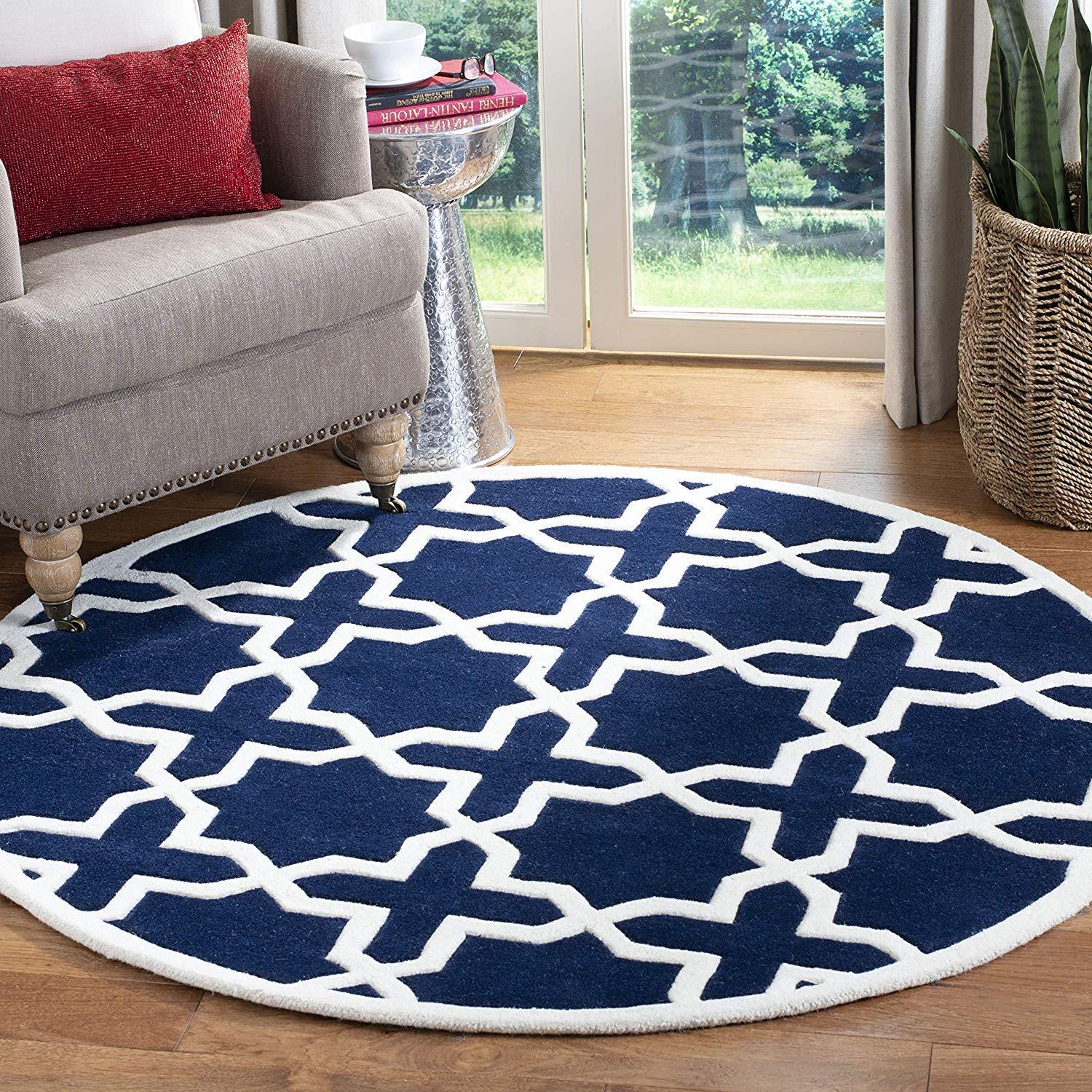 Round navy blue and white wool carpet rug in modern living room, Bhadohi Carpets House