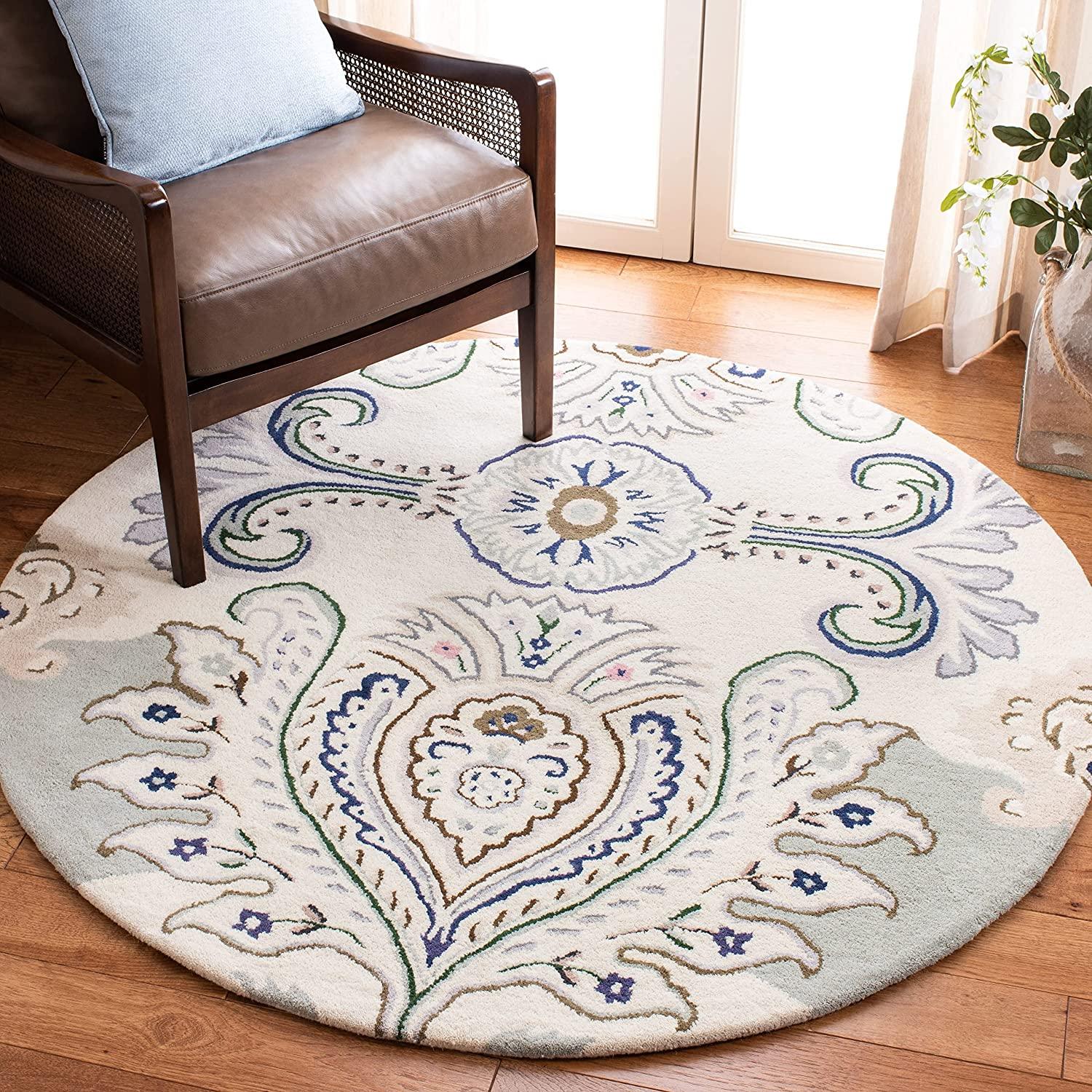 Ivory round wool carpet rug with peacock feather design in living room, Bhadohi Carpets House