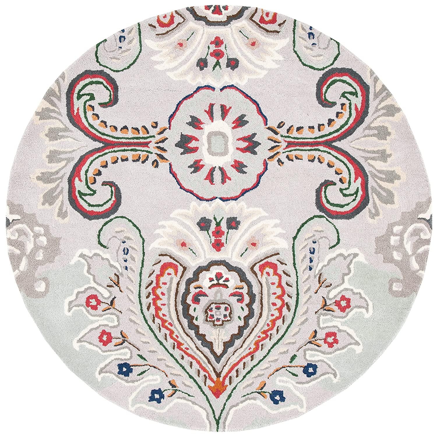 Ivory round wool carpet with peacock feather pattern from Bhadohi Carpets House