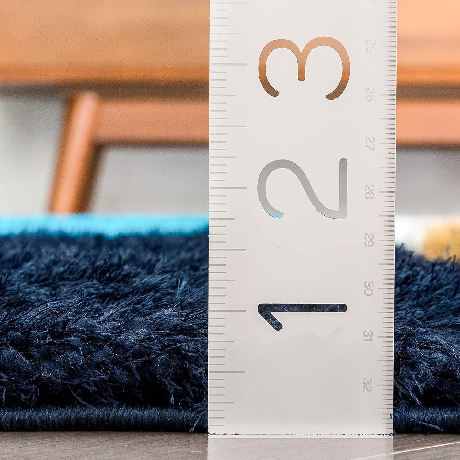 Close-up of thick navy blue shaggy carpet with ruler measuring pile height, Bhadohi Carpets House