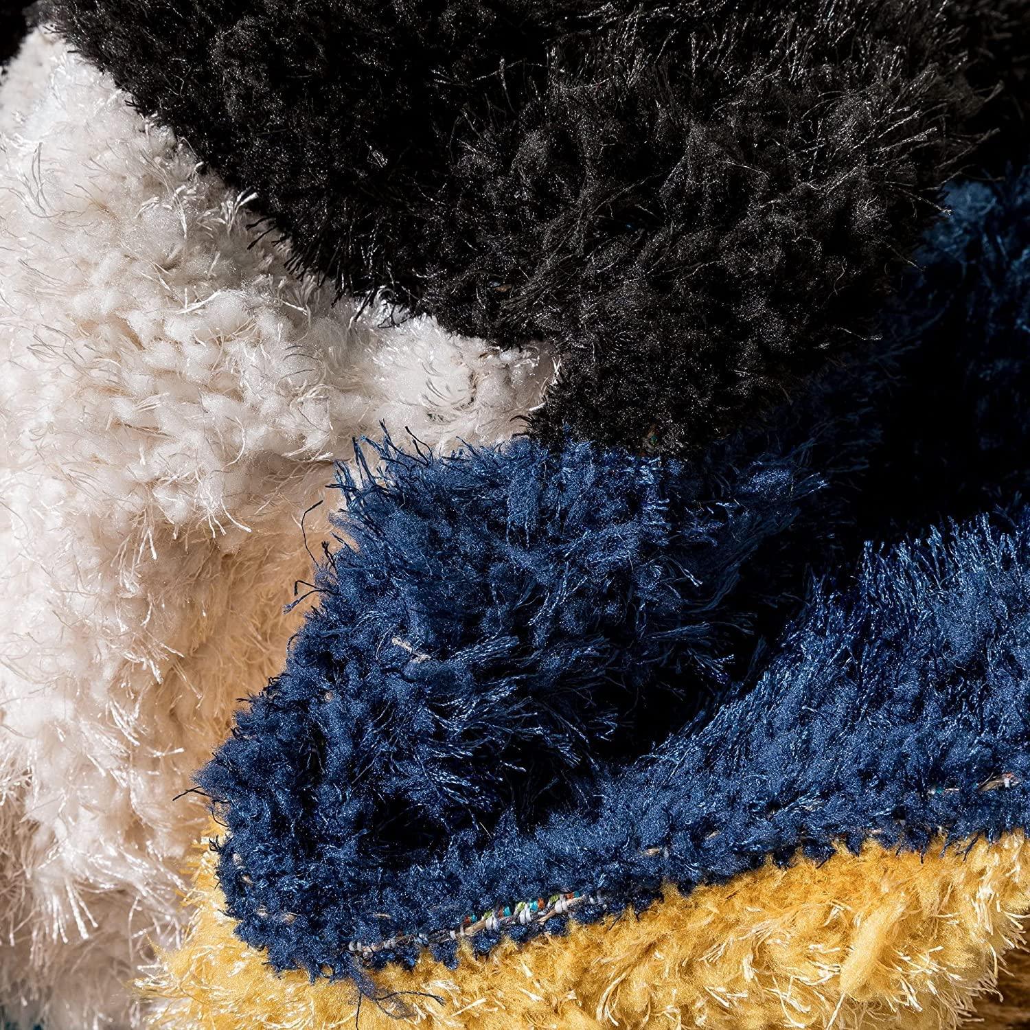 Close-up of multicolor shaggy carpet rug with black, white, blue, and yellow fibers from Bhadohi Carpets House