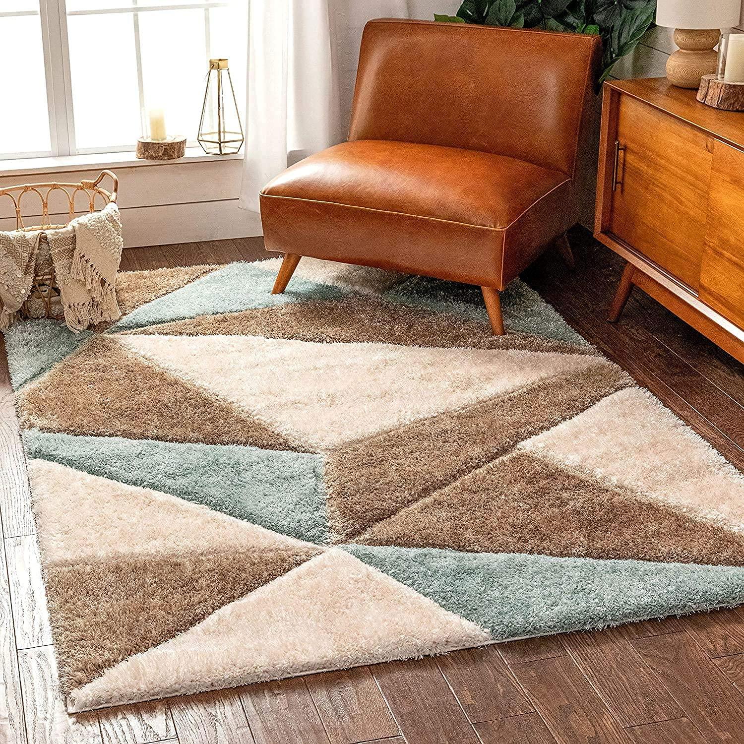 Modern geometric shaggy rug in beige, brown, and light blue in a cozy living room setting
