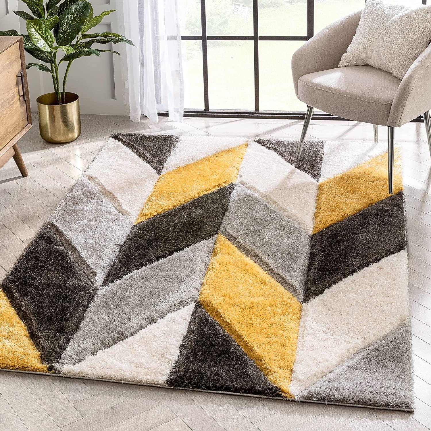 Modern shaggy geometric carpet rug with yellow, grey, and white patterns in a living room