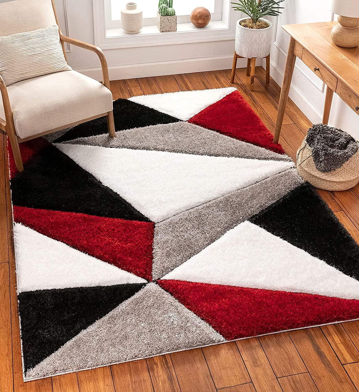 Modern shaggy geometric rug with red, black, grey, and white triangles in a cozy living room from Bhadohi Carpets House