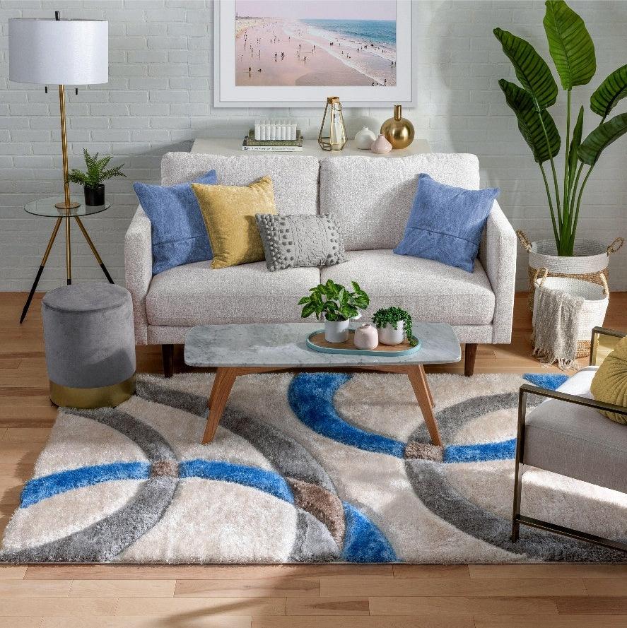 Modern living room with Bhadohi shaggy carpet rug featuring blue, grey, and beige patterns