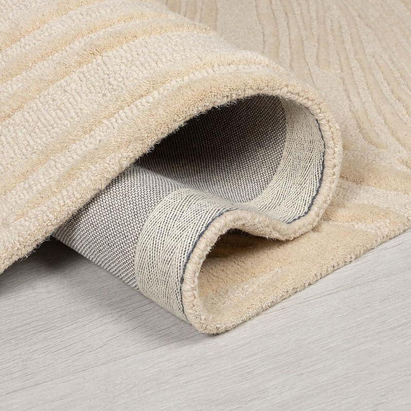 Beige loop cut carpet rug with textured pattern by Bhadohi Carpets House on wood floor