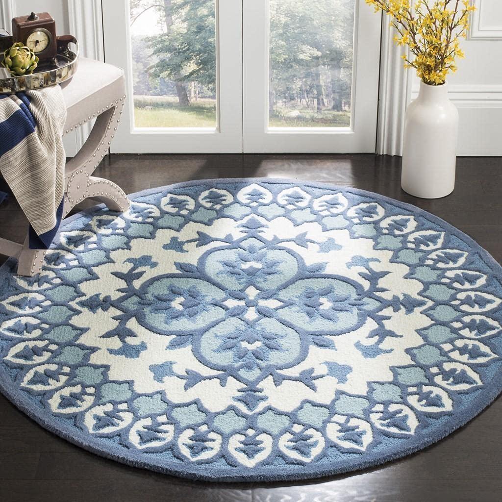 Blue and white round wool carpet with floral pattern in a modern living room, Bhadohi Carpets House