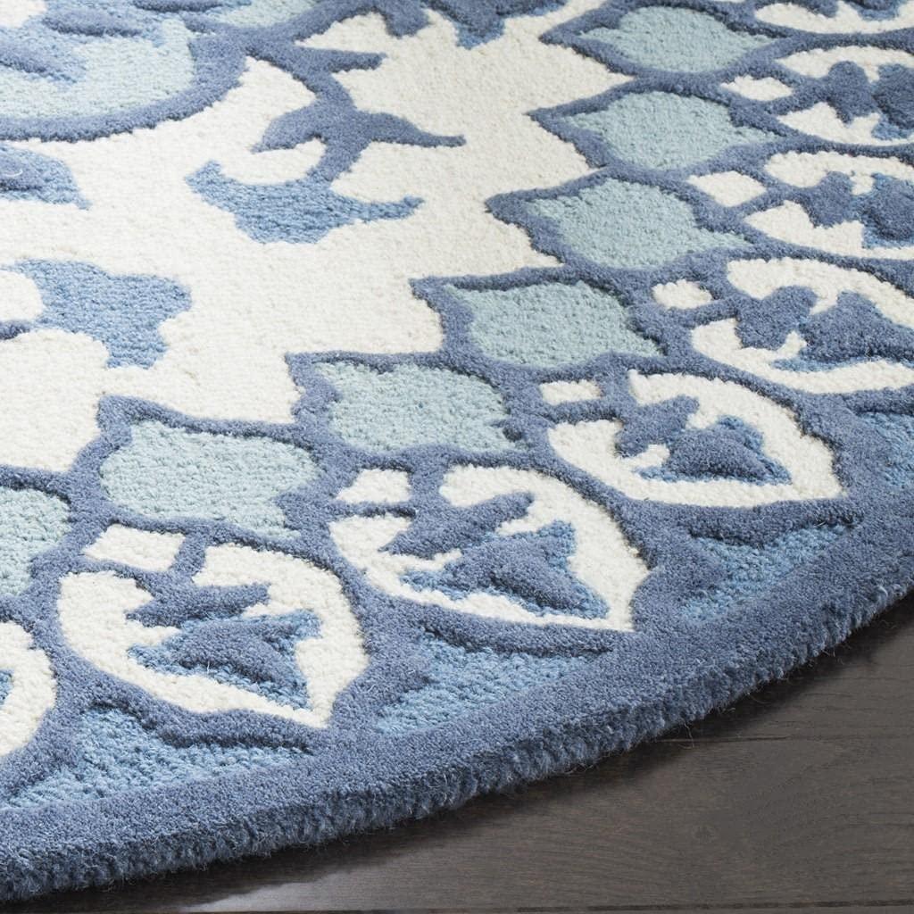 Round wool carpet rug in blue and white floral pattern on wood floor from Bhadohi Carpets House