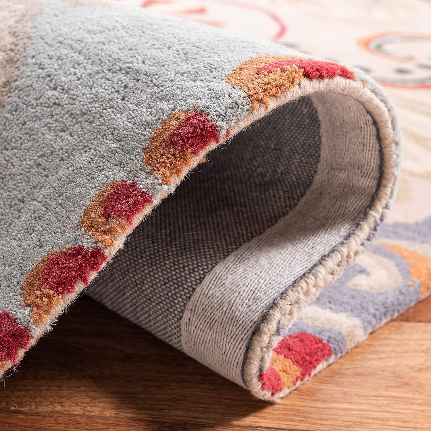 Close-up of Bhadohi Carpets House round wool rug with peach and peacock feather patterns.