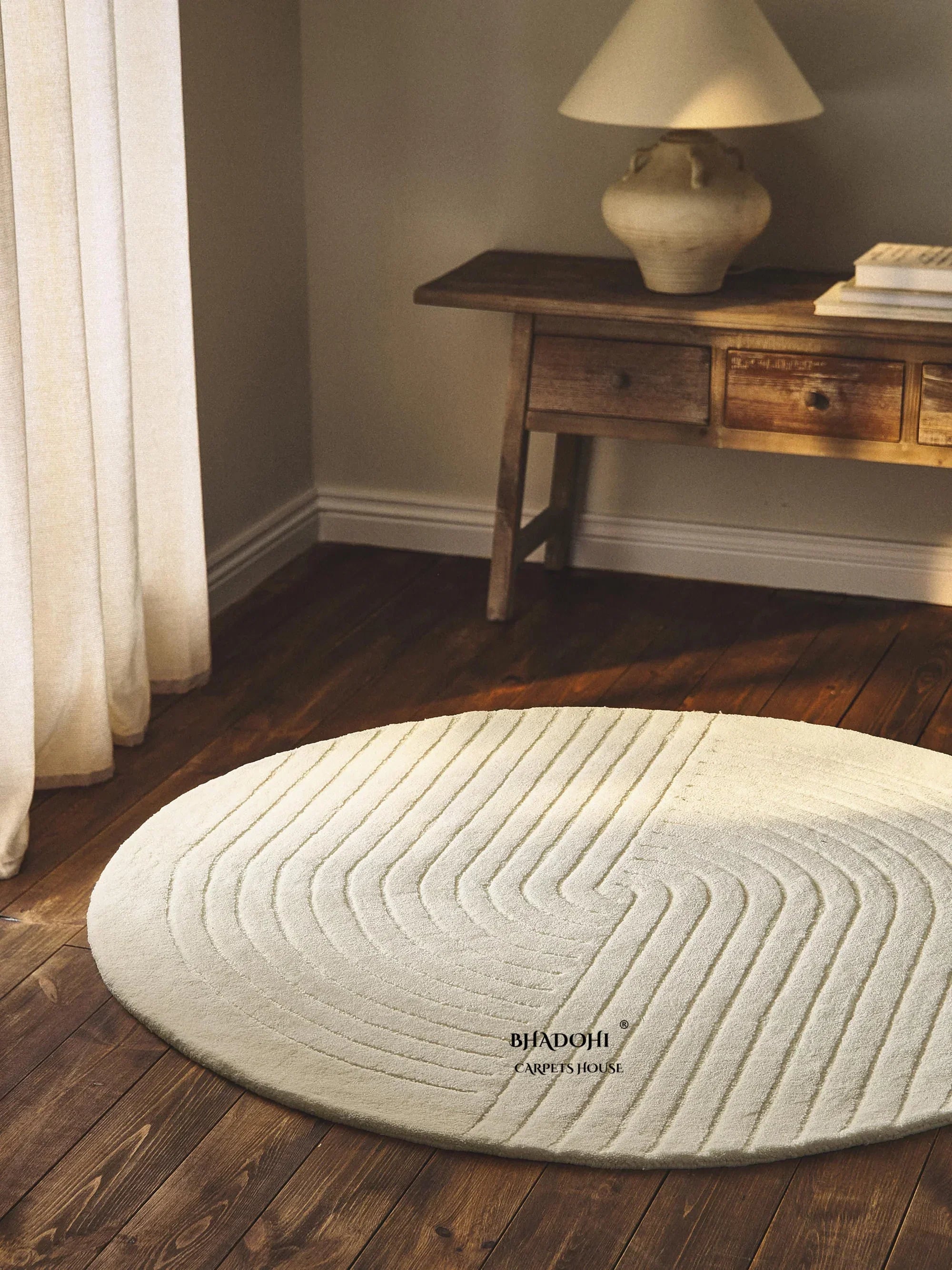 Round wool carpet rug by Bhadohi Carpets House in a modern Indian home with wooden flooring.