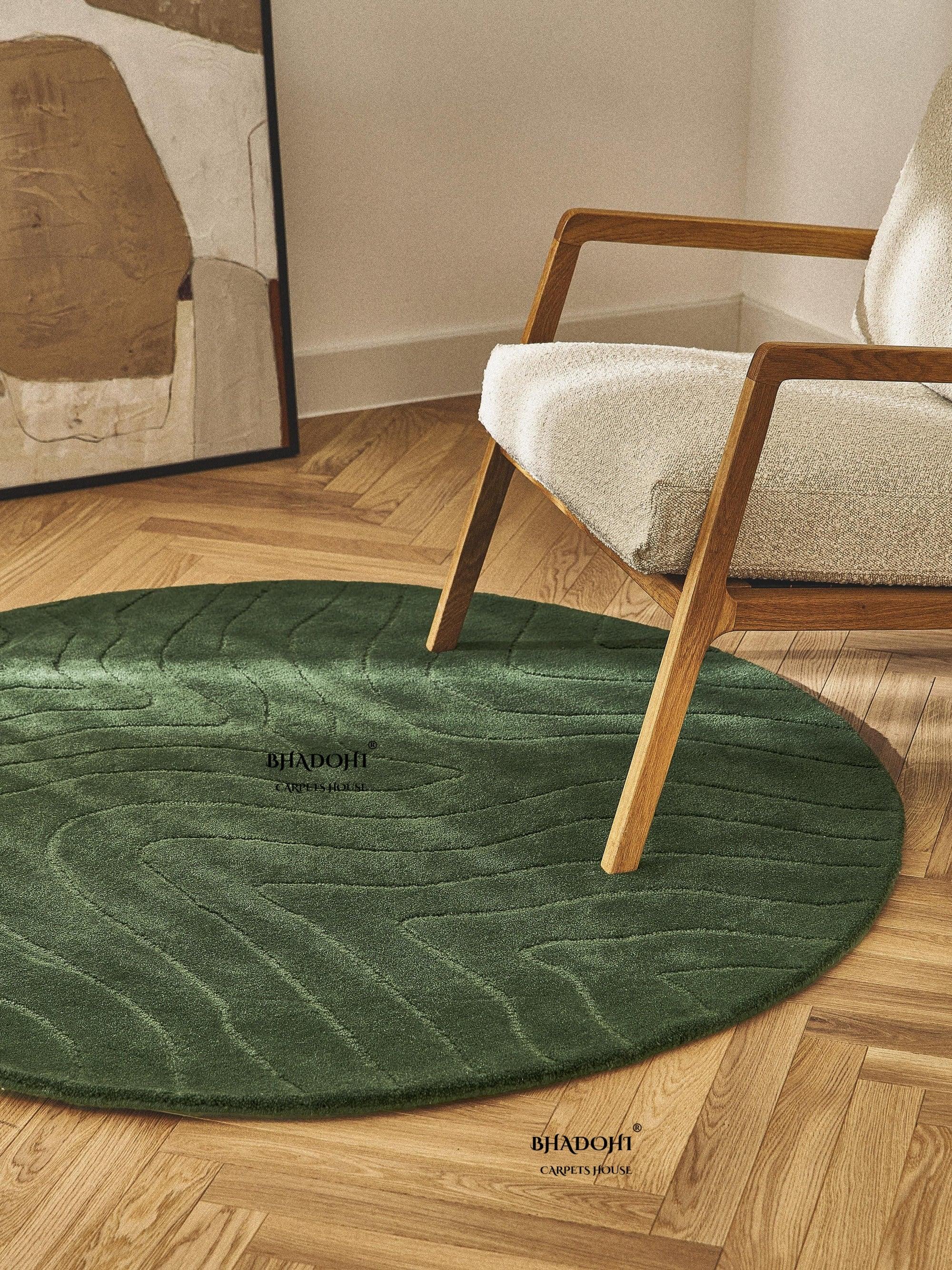 Green round wool carpet rug by Bhadohi Carpets House in modern living room with wooden chair