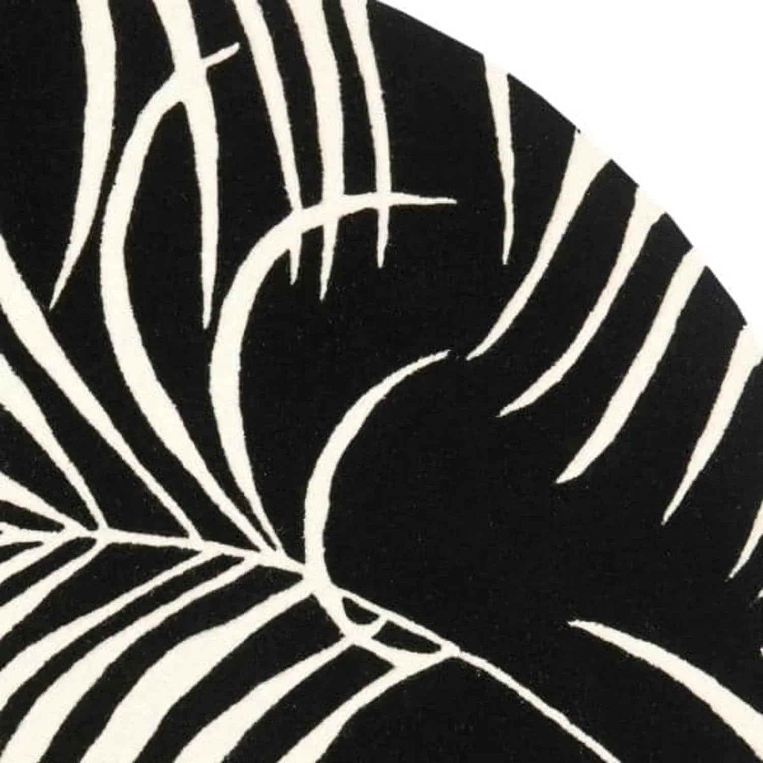 Black and white round wool rug with bold leaf pattern, Bhadohi Carpets House