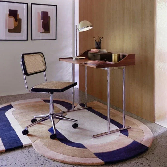 Modern home office with stylish curved Bhadohi Carpets House rug, desk, and art prints