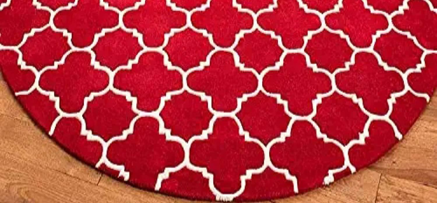 Red round wool carpet with white lattice pattern on wooden floor, Bhadohi Carpets House