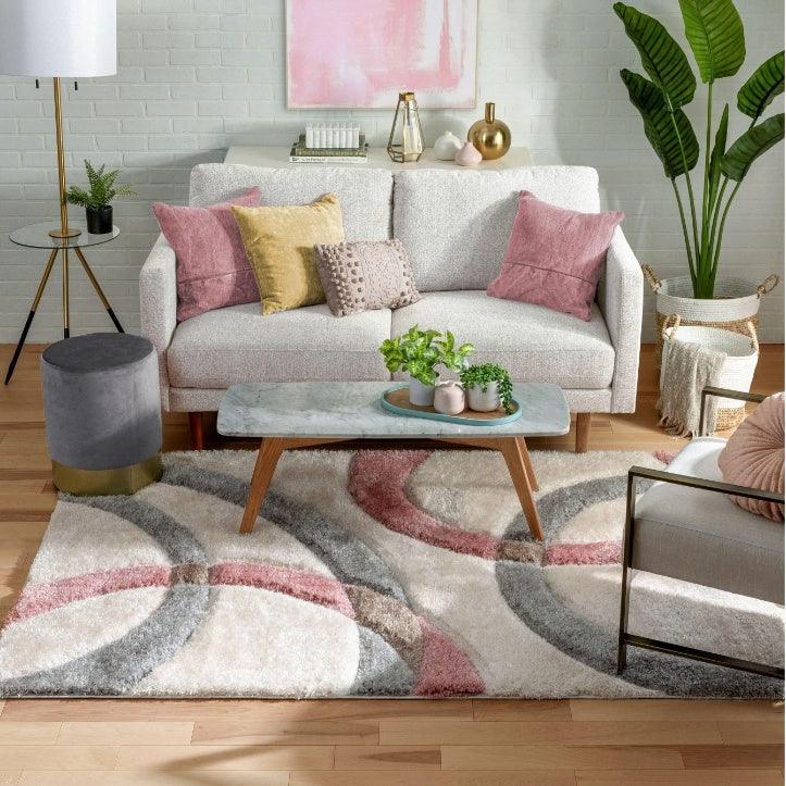 Modern living room with Bhadohi shaggy carpet rug, geometric pattern, neutral furniture, plants