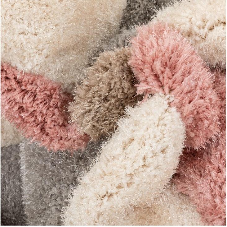 Close-up of multicolor shaggy carpet rug with soft cream, pink, and beige fibers from Bhadohi Carpets House