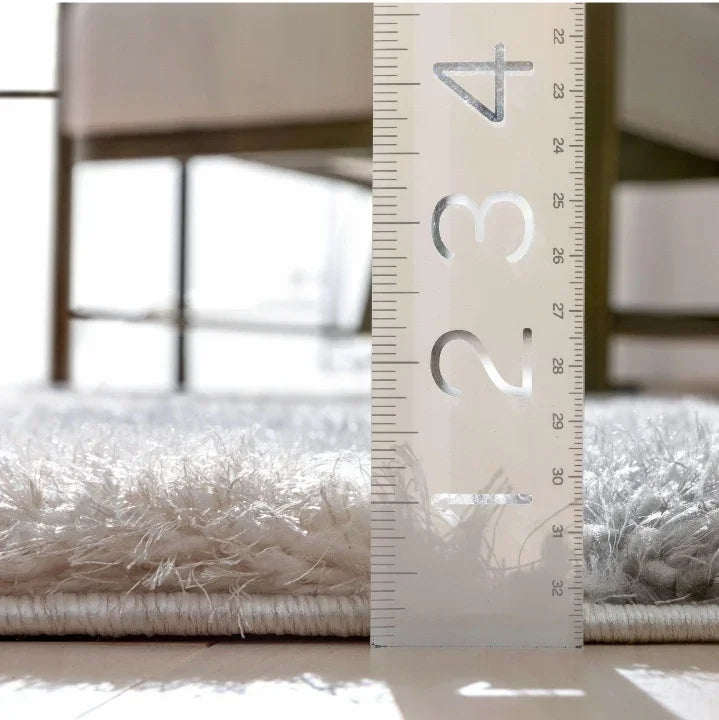 Close-up of Serene Shaggy carpet rug from Bhadohi Carpets House with ruler showing pile height.