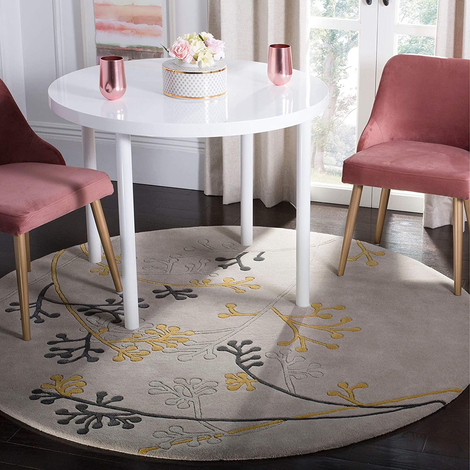 Silver berry round wool carpet rug from Bhadohi Carpets House under modern dining table