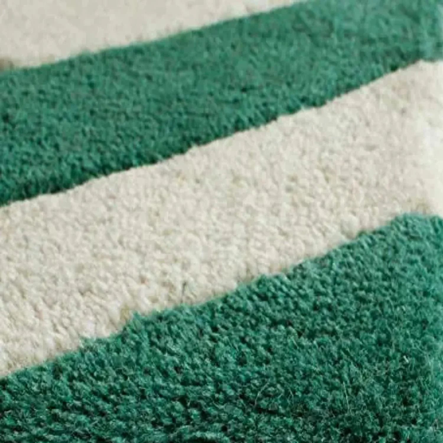 Close-up of green and white striped wool carpet rug from Bhadohi Carpets House