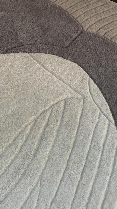 Modern textured carpet with irregular patterns in grey and cream from Bhadohi Carpets House