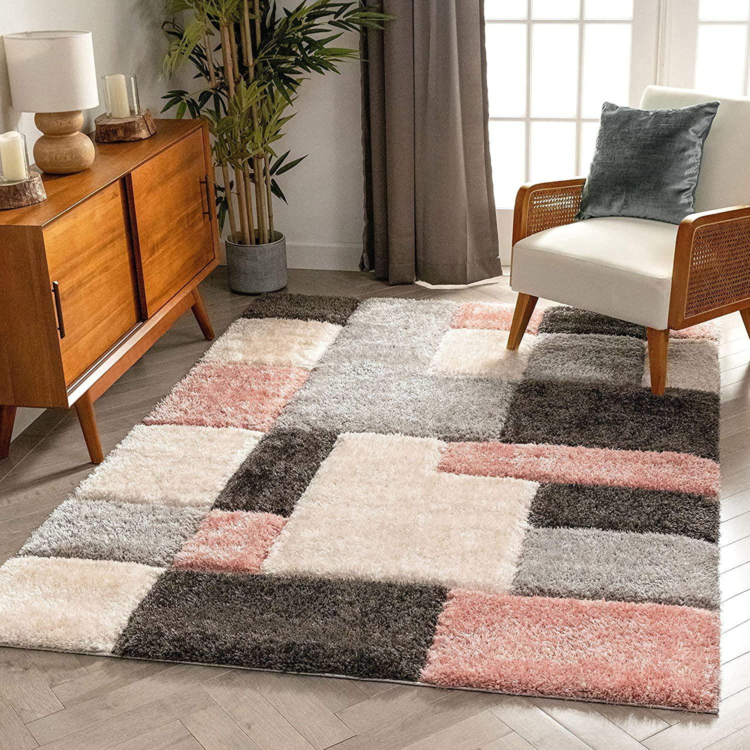 Modern Indian living room with geometric shaggy carpet rug in pink, grey, and cream tones from Bhadohi Carpets House.