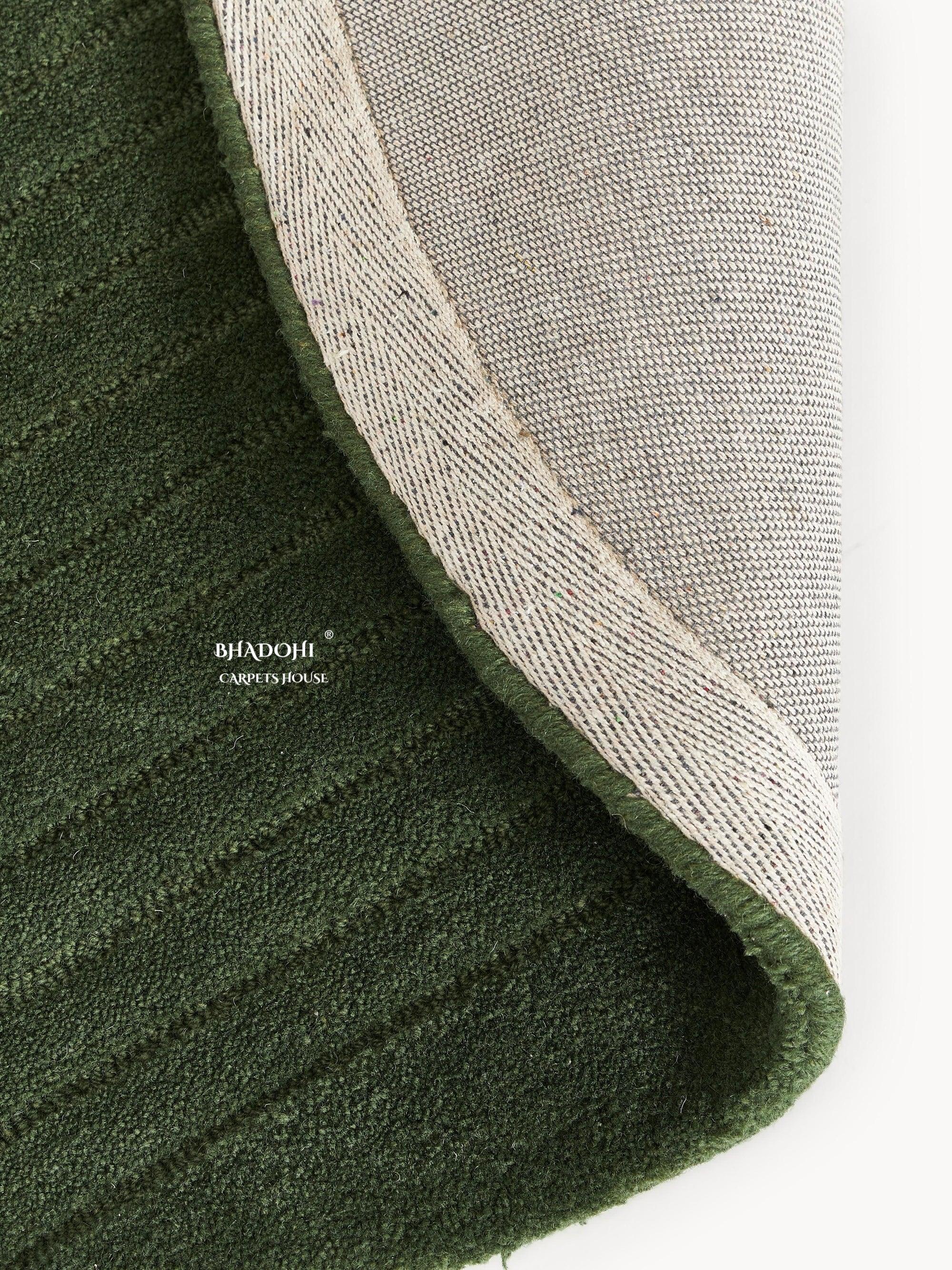 Green wool carpet rug with textured pattern by Bhadohi Carpets House, corner flipped up
