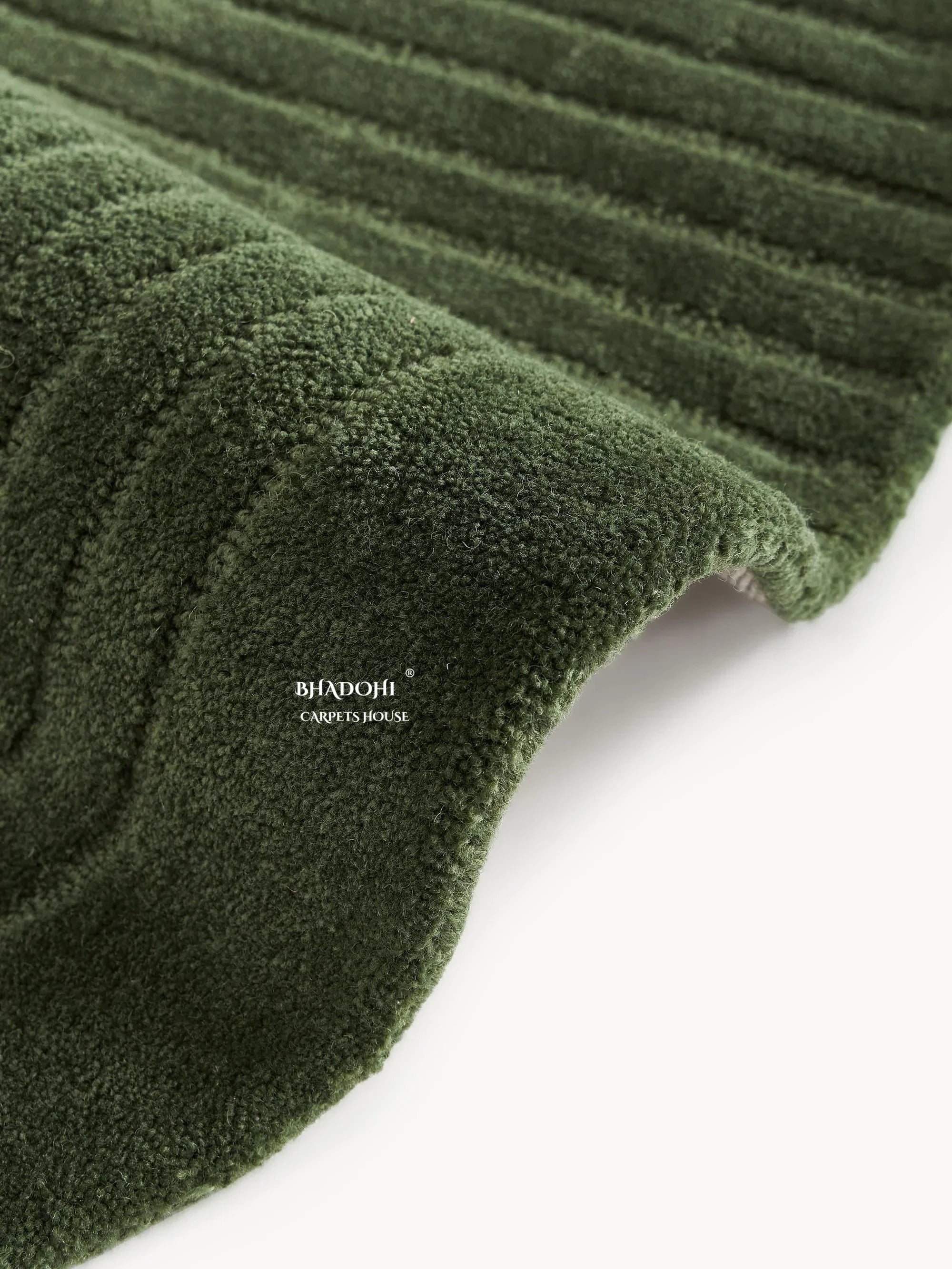 Green textured wool carpet rug from Bhadohi Carpets House, close-up view