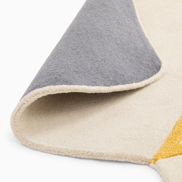 Irregular shape cream and yellow carpet rug corner, soft texture, Bhadohi Carpets House