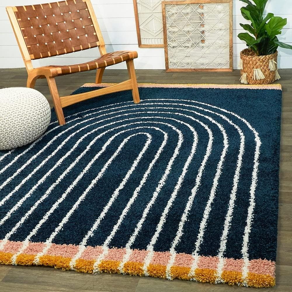 Modern shaggy carpet rug with geometric pattern in stylish living room setting at Bhadohi Carpets House.