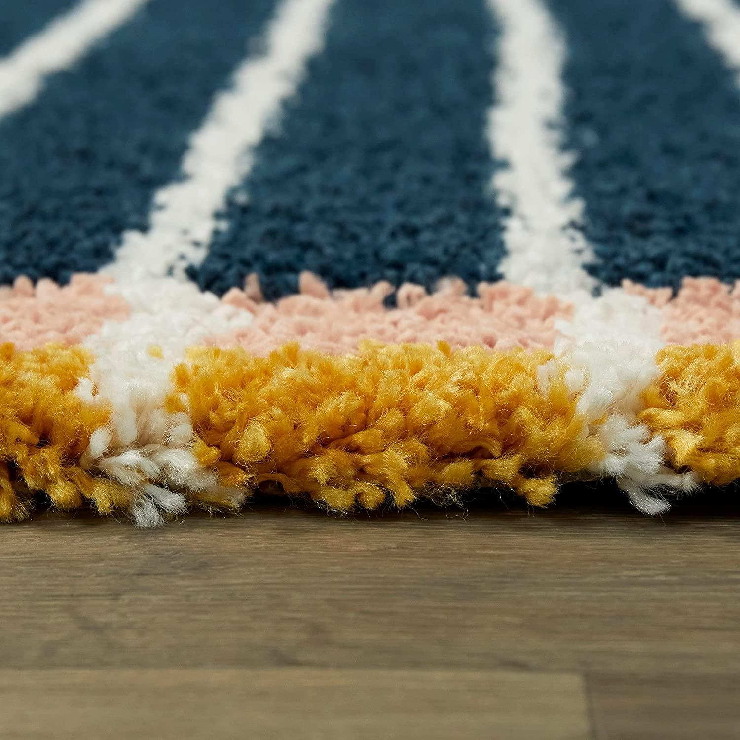 Close-up of a thick shaggy carpet with navy, yellow, pink, and white stripes on wooden floor, Bhadohi Carpets House