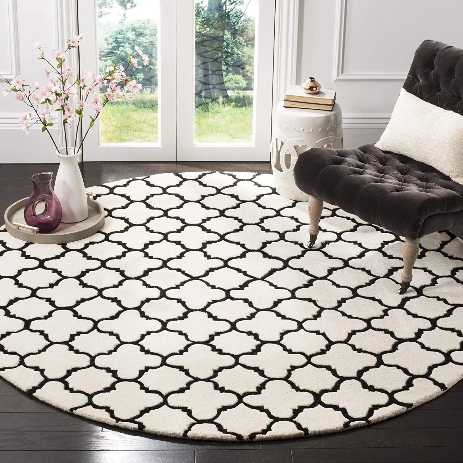 White round wool carpet with black geometric pattern in a modern living room, Bhadohi Carpets House
