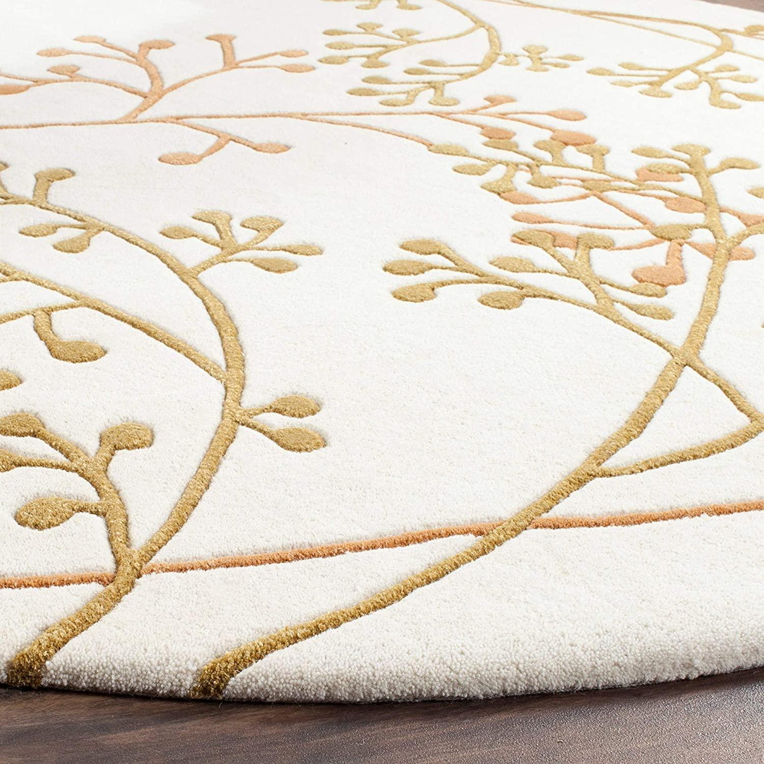 White round wool carpet with gold berry vine pattern from Bhadohi Carpets House