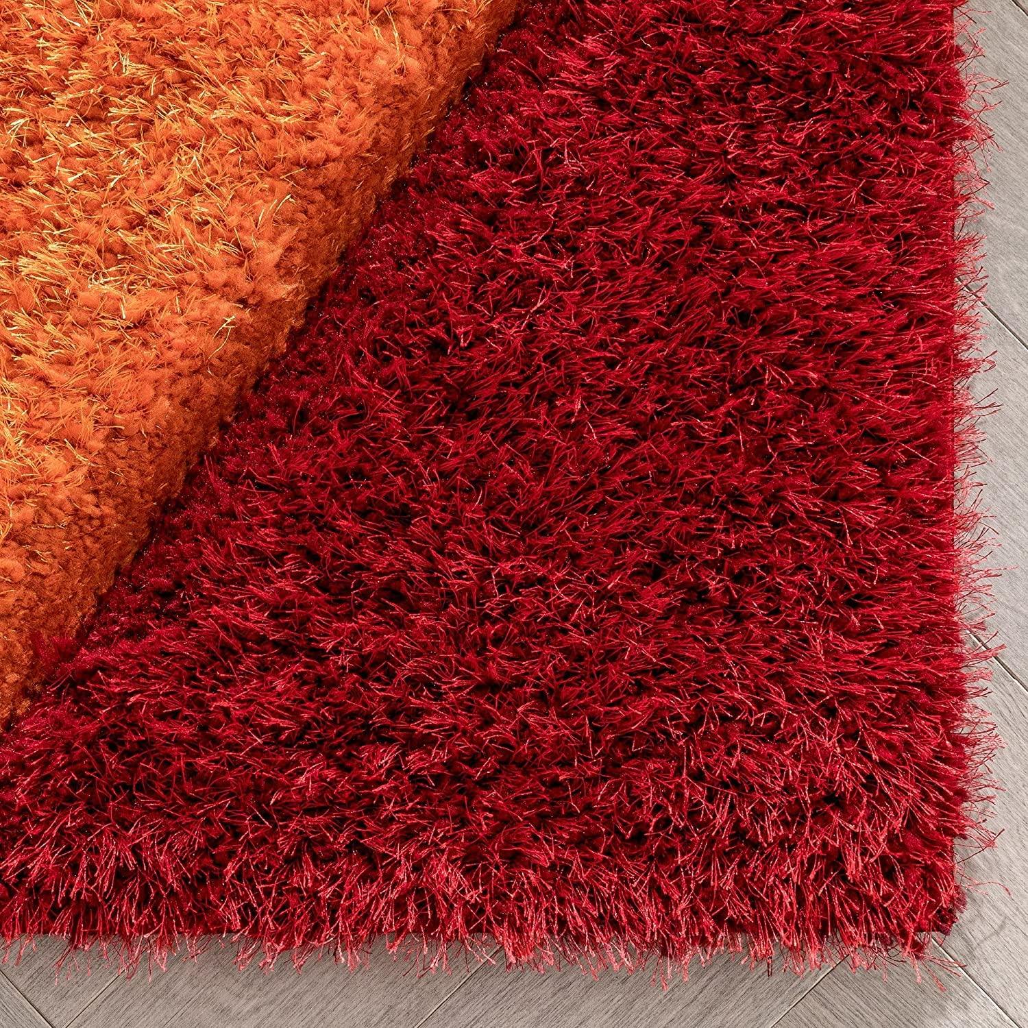 Close-up of red and orange Zen shaggy carpet rug from Bhadohi Carpets House on wooden floor